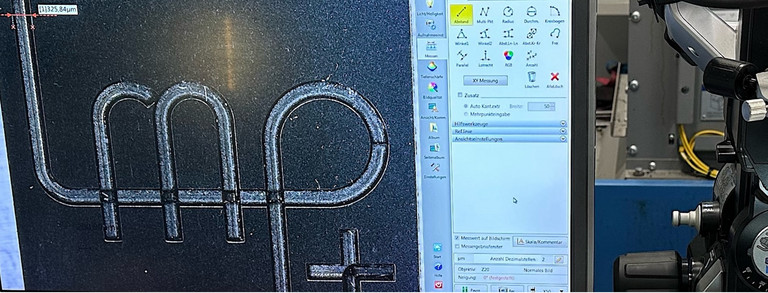 Mikroskopie einer mittels Laserstrahlung bearbeiteten PKD-Platte mit LMP Logo